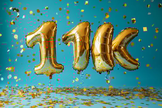 Celebration of Achieving 11K With Golden Balloons and Confetti on a Teal Background photo