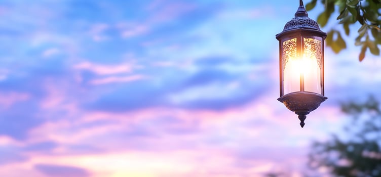 Illuminated lantern hanging against a colorful sky evening scene photo