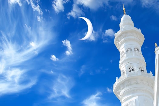 White building under blue sky with crescent moon architecture design photo