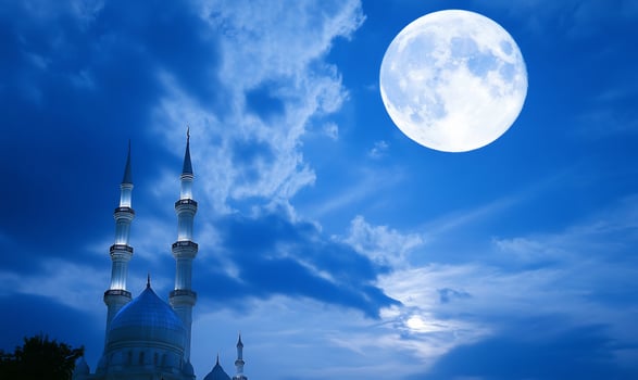 Mosque at night under a full moon architecture and serene sky photo