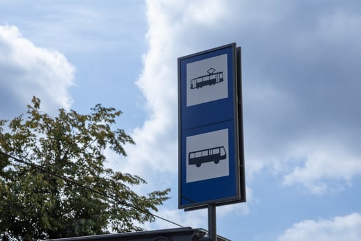 A prominent blue public transport sign clearly displays distinct tram and bus icons, precisely indicating a vital urban stop for convenient city travel and efficient daily commuting options photo