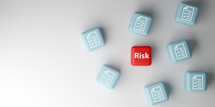 Business risk management, legal compliance, and identifying potential dangers.3D illustration of a red cube labeled Risk among blue cubes with document icons. photo