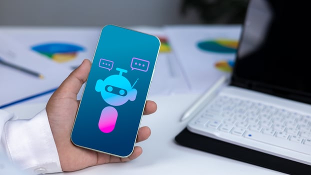 AI technology, virtual assistants, and digital customer service in a modern business environment. Close-up of hand holding smartphone with chatbot icon. photo