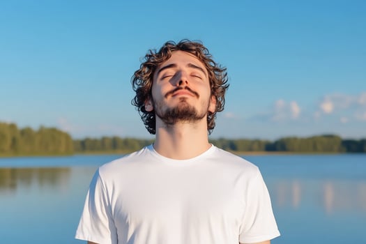 Man meditating peacefully under sunlight by the lake enjoying nature photo