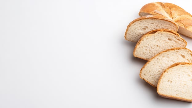 Sliced bread loaf on white background for culinary and dietary uses photo