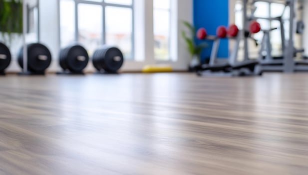 Fitness center interior with blurred weight training equipment and bright natural light photo