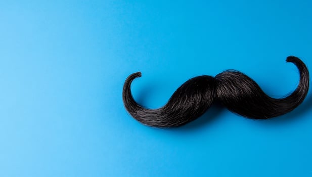 Elegant black mustache on blue background decorative male symbol photo