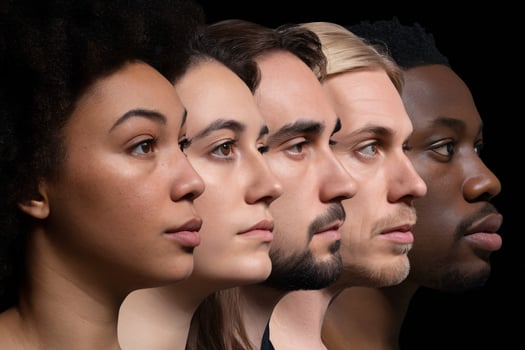 A diverse group of five individuals portraying different ethnicities in profile against a dark background. photo