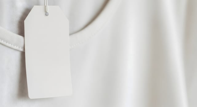 Blank white clothing tag on a t-shirt, close-up mockup for price, brand, or sale text. photo