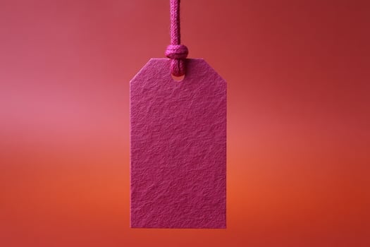 Pink textured tag suspended in ethereal twilight, evoking whispers of Secret Santa exchanges and whimsical National Stationery Week celebrations photo