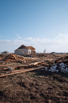 A lone rustic house stands resilient amidst sprawling debris, evoking themes of renewal during Earth Day and Bonfire Night photo