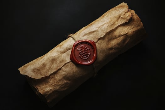 Rolled ancient parchment tied with twine displays its authentic wax seal on black photo