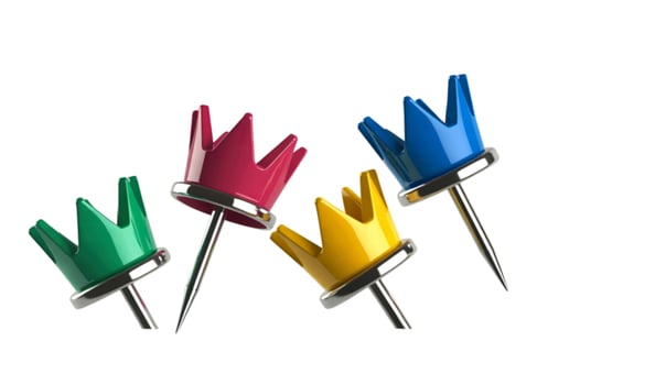 Colorful crown shaped pushpins representing royalty and leadership photo