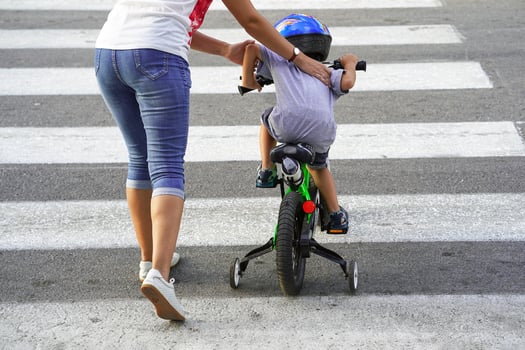 Mother with son with a bicycle on a zebra photo