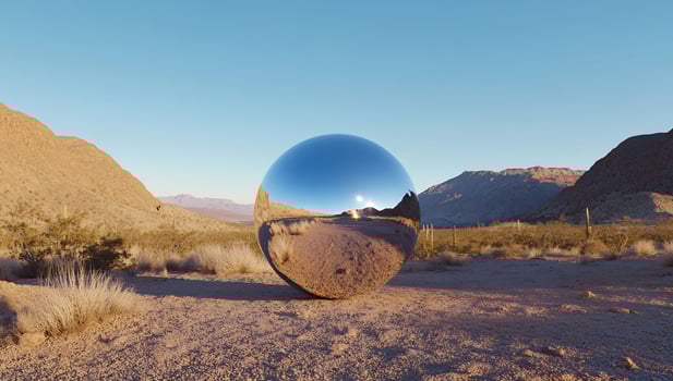 Reflective sphere in desert landscape optical illusion photo