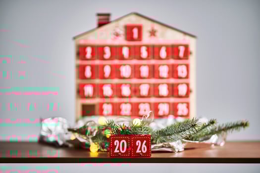 Christmas Advent calendar in the shape of a house with boxes making up the number 2026. photo