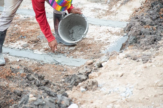 Workers are applying cement to the floor. photo