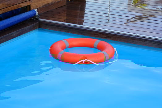 Red lifebuoy pool ring float in hotel photo