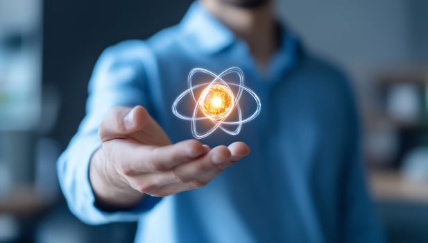 Atom in hand symbolizing science and technology solutions photo