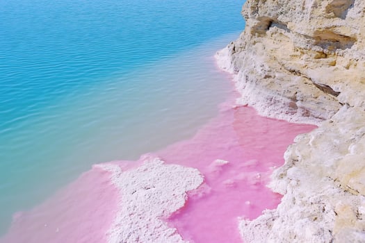 Pink shoreline meets azure sea coastal landscape photo