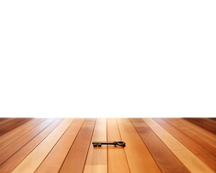 A single antique key rests on a polished wooden floor photo
