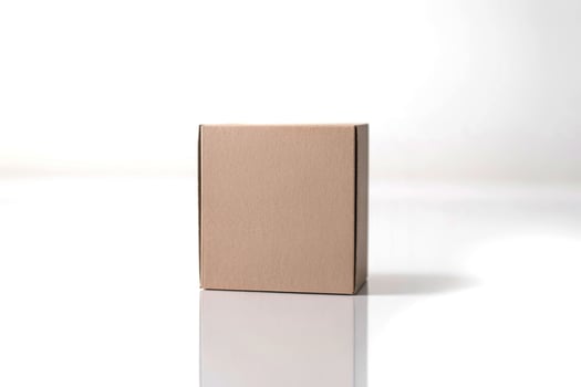 A cardboard box sitting on a white surface photo