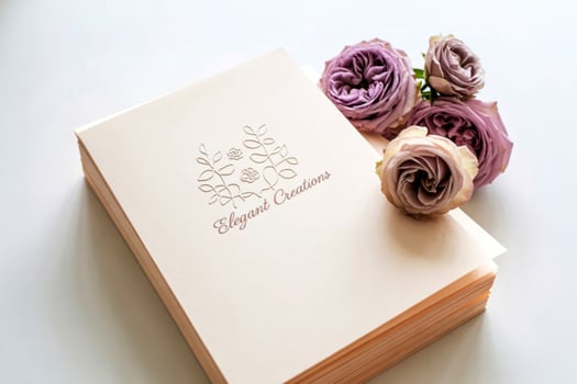Stack of elegant cream wedding invitations with roses photo
