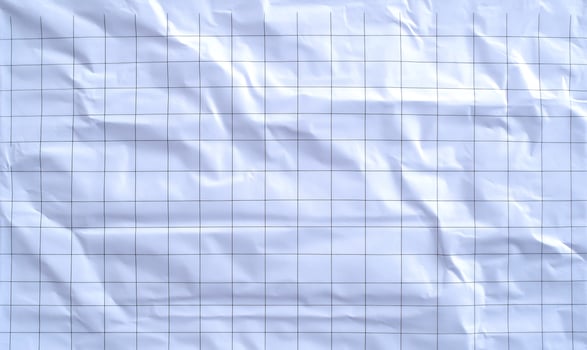 Crumpled graph paper texture background close up overhead photo