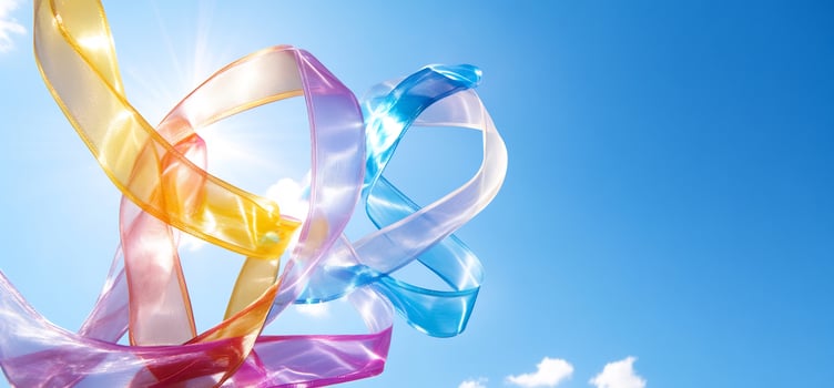 Colorful ribbons swirling in a clear blue sky abstract design element photo