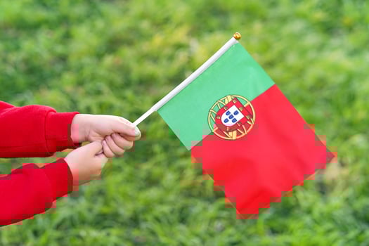 Little girl hands hold Portugal flag photo