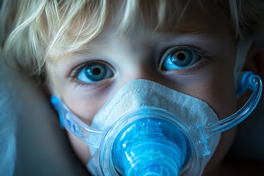 Child With Blue Eyes Using Inhaler at Home During Evening for Respiratory Treatment. photo