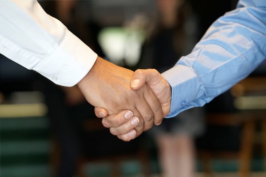 Two business men shaking hands, teamwork photo