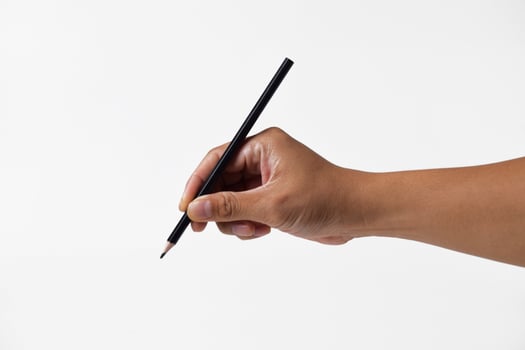 Asian mans hand holding pencil with white background photo