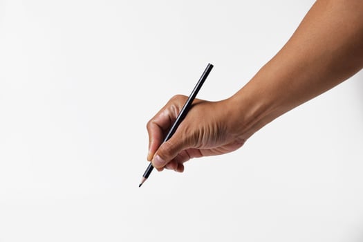 Closeup of Asian man holding black pencil on white background photo