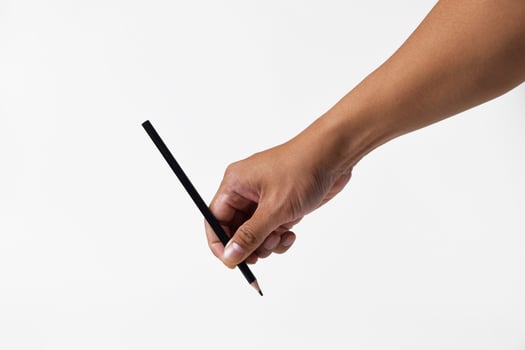 Closeup of hand holding pencil as if writing on white background photo