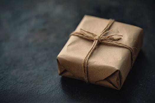 Wrapped craft package presents simple beauty using neutral color paper and string knot photo