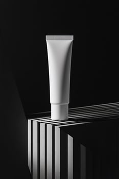 White squeezable tube stands elegantly on the creative monochrome stage, emphasizing shadow interplay, a transparent background photo
