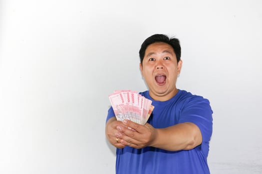 A man holding up a bunch of money photo