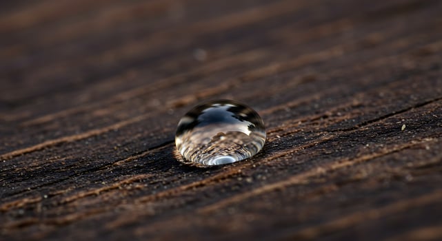 Water Droplet Reflecting on Wooden Surface. photo