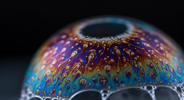 A colorful glass ball with bubbles on top photo