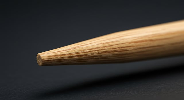 A close up of a wooden pencil on a black surface photo