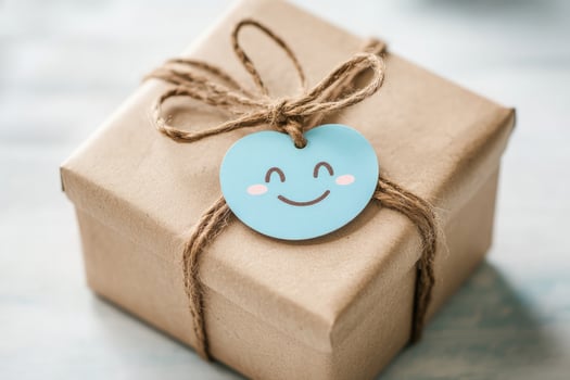 Kraft paper box rests on surface, adorned with twine and smiley face tag photo