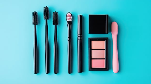 Flat lay shows black brushes and makeup, featuring pink accents, on a vibrant blue surface photo
