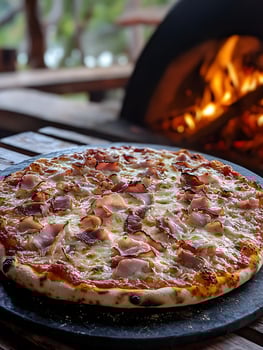 Delicious Ham and Cheese Pizza Fresh from a Wood Fired Oven. photo