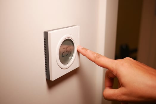 Adjusting the thermostat for a comfortable home temperature photo