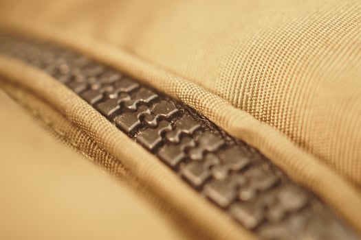 Detailed close-up of a zipper on fabric material photo