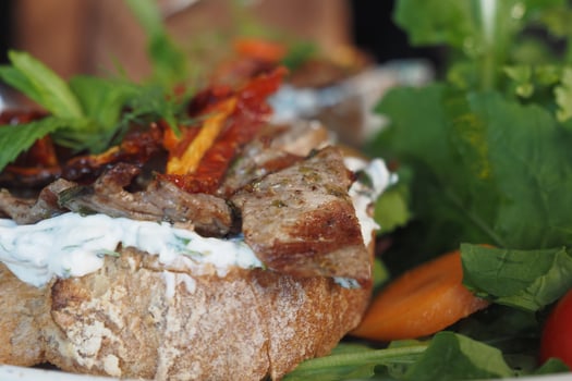 Delicious Open-Faced Sandwich with Grilled Meat and Fresh Vegetables photo