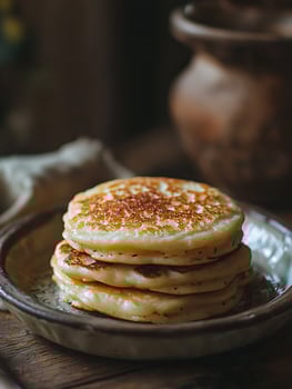 A Stack of Golden Brown Pancakes on a Rustic Plate. photo