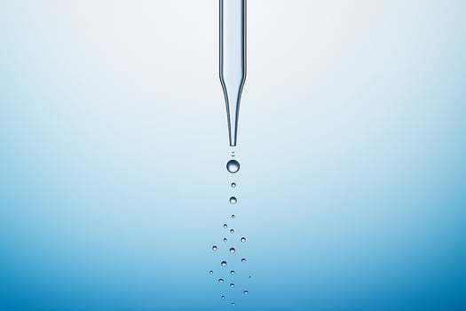 minimal close up of a vertical dropper releasing multiple clear droplets in a line against a smooth blue gradient background symbolizing purity science and precision photo