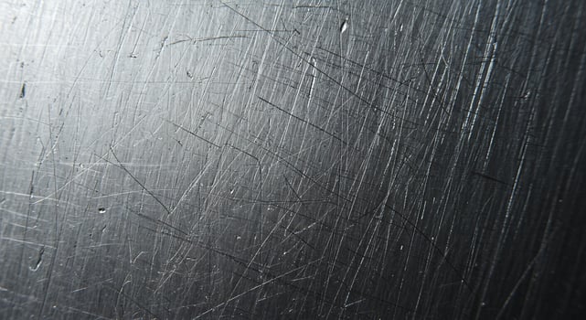 Scratched Metal Surface Texture with Light Reflections and Dark Shadows photo